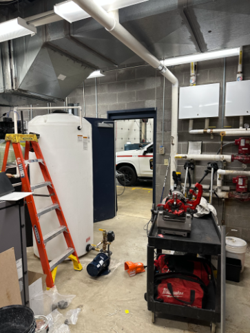 On-site commercial fire protection system service, testing equipment, and storage tank setup.
